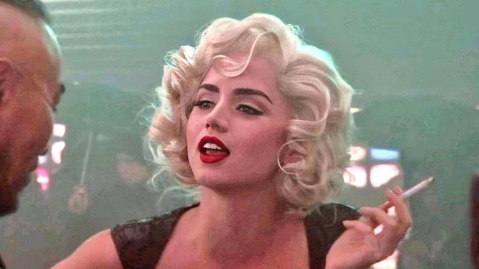 Blonde Ana de Armas as Marilyn Monroe holding a cigarette