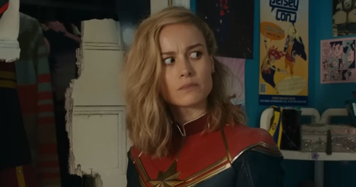 Captain Marvel looking through Kamala's room with her pictures on the wall