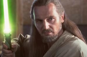 Qui-Gon Jinn (Liam Neeson) holding a green lightsaber in Star Wars: The Phantom Menace