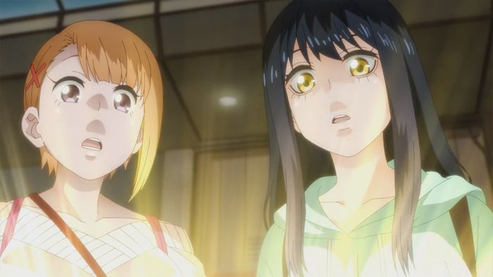Hana and Miko looking amazed over a glowing object.
