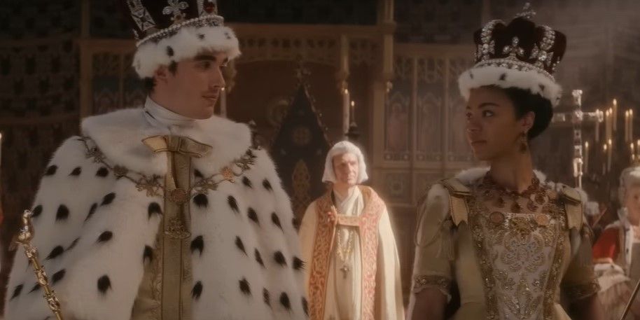 King George and Queen Charlotte smiling at each other during Coronation Day