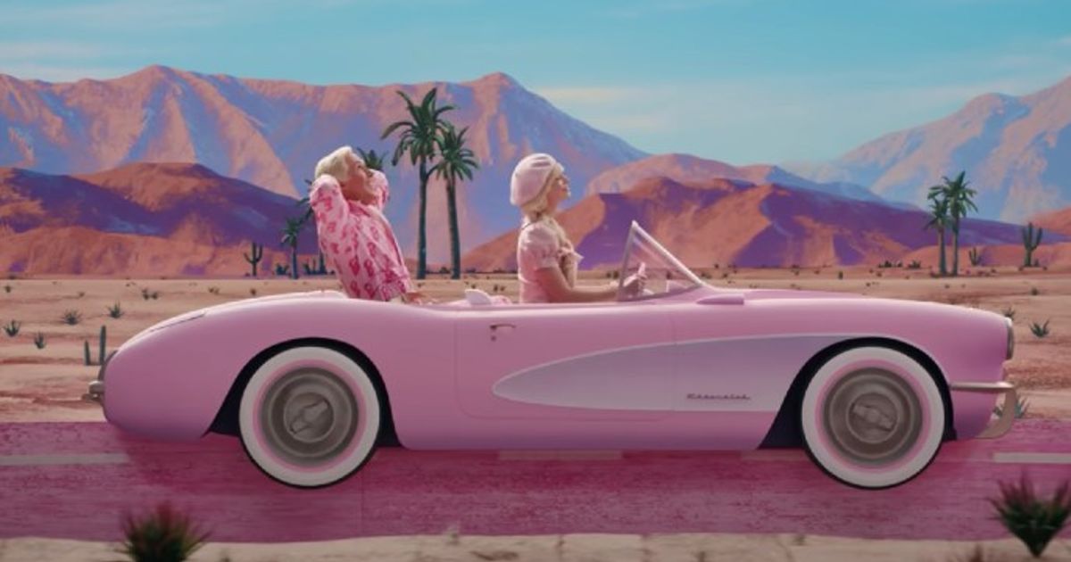 Ryan Gosling as Ken, Margot Robbie as Barbie driving a pink Chevrolet Corvette in Barbie