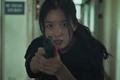 Happiness Han Hyo-Joo as Yoon Sae-bom holding a gun towards camera