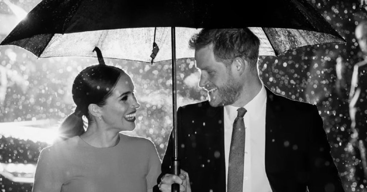 Prince Harry, Meghan Markle under an umbrella