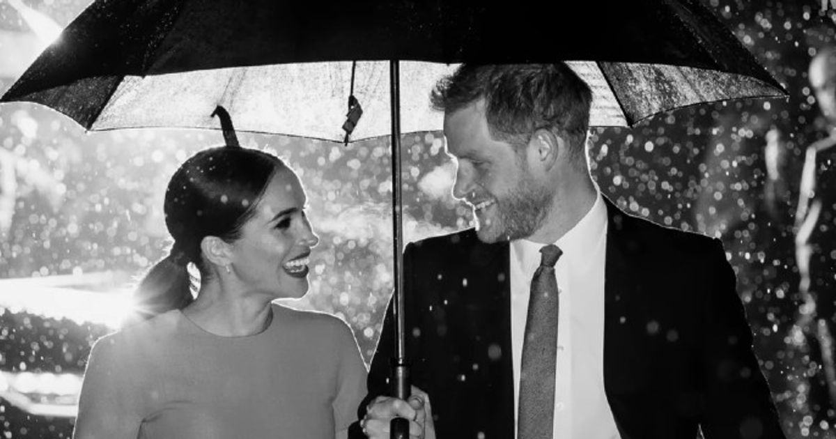 Prince Harry, Meghan Markle under an umbrella