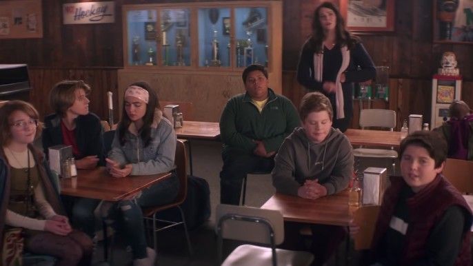 the mighty ducks: game changers season 1 ice hockey players and Lauren Graham as Alex Morrow watching a game on TV
