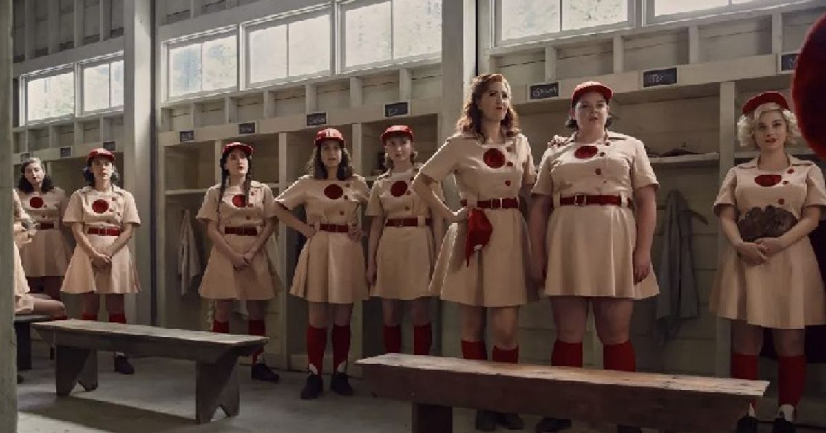 A League of Their Own show cast wearing their baseball uniform