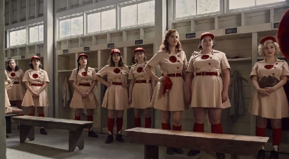 A League of Their Own show cast wearing their baseball uniform