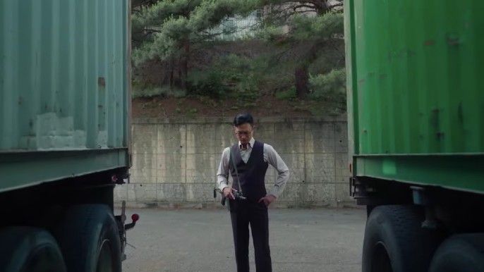 Happiness Park Jo Woo-jin as Han Tae-seok stands between two green container vans filled with infected people