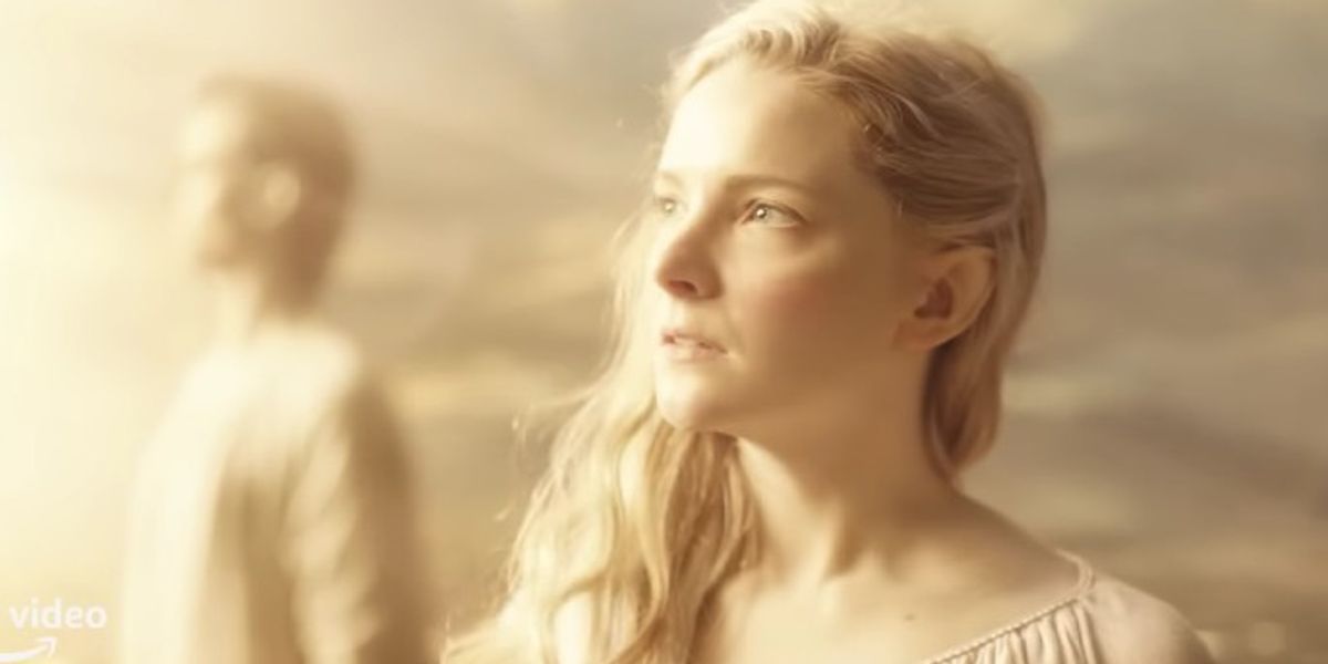 lotr rings of power morfydd clark as galadriel staring into the distance bright light