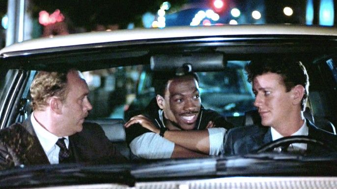 Beverly Hills Cop 1984 Eddie Murphy as Axel Foley, John Ashton as Det. Sgt. John Taggart and Judge Reinhold as Det. William "Billy" Rosewood in a car